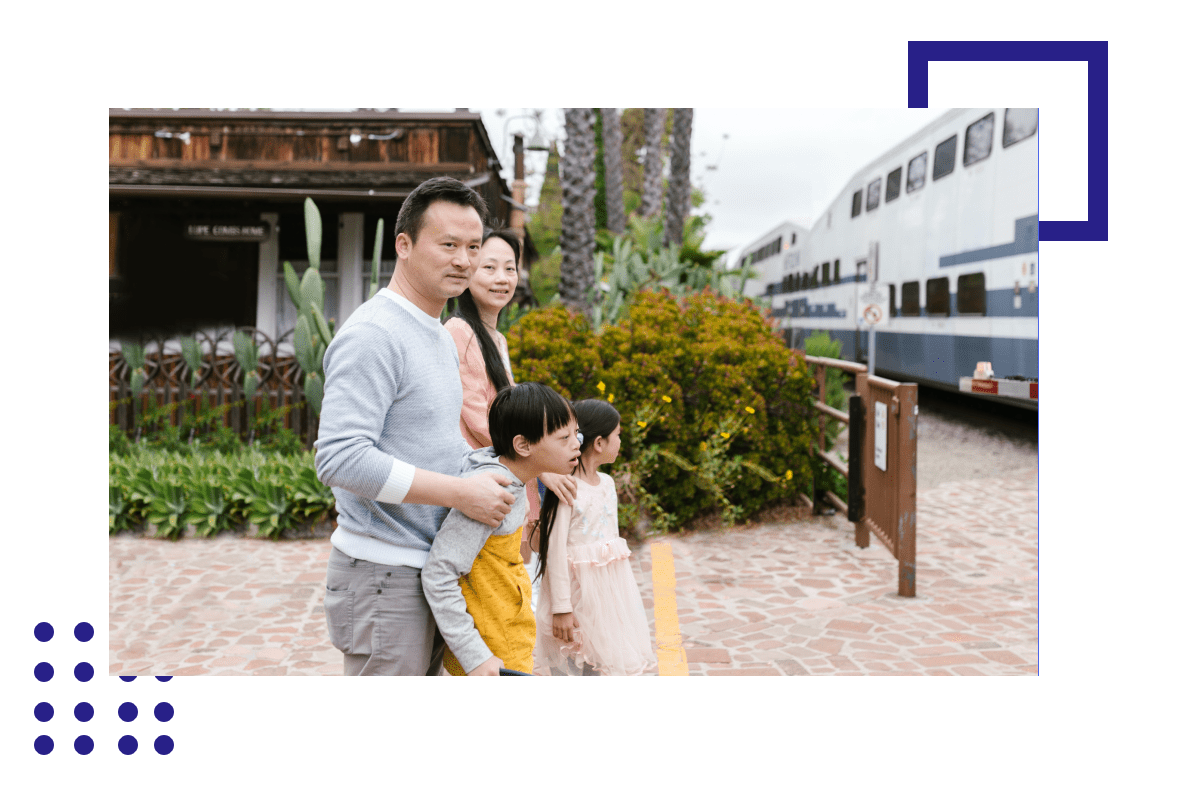 A family is standing in front of a train.