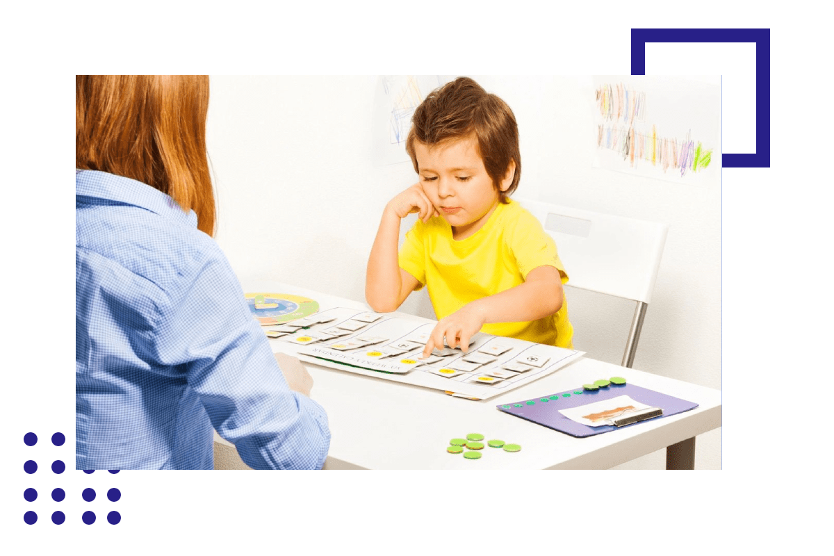 A child is playing with a puzzle while an adult watches.