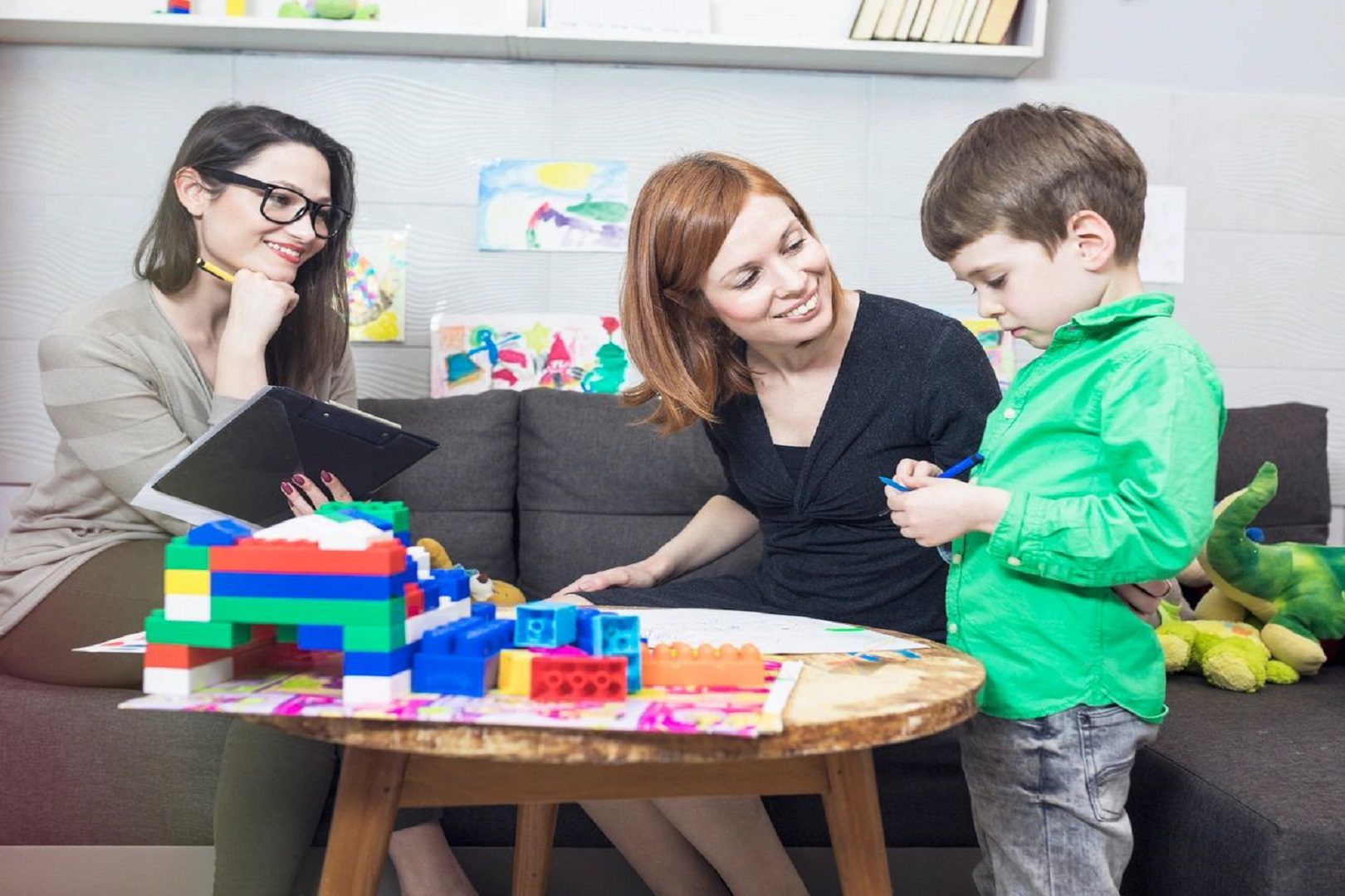 A woman and two children sitting at a table.