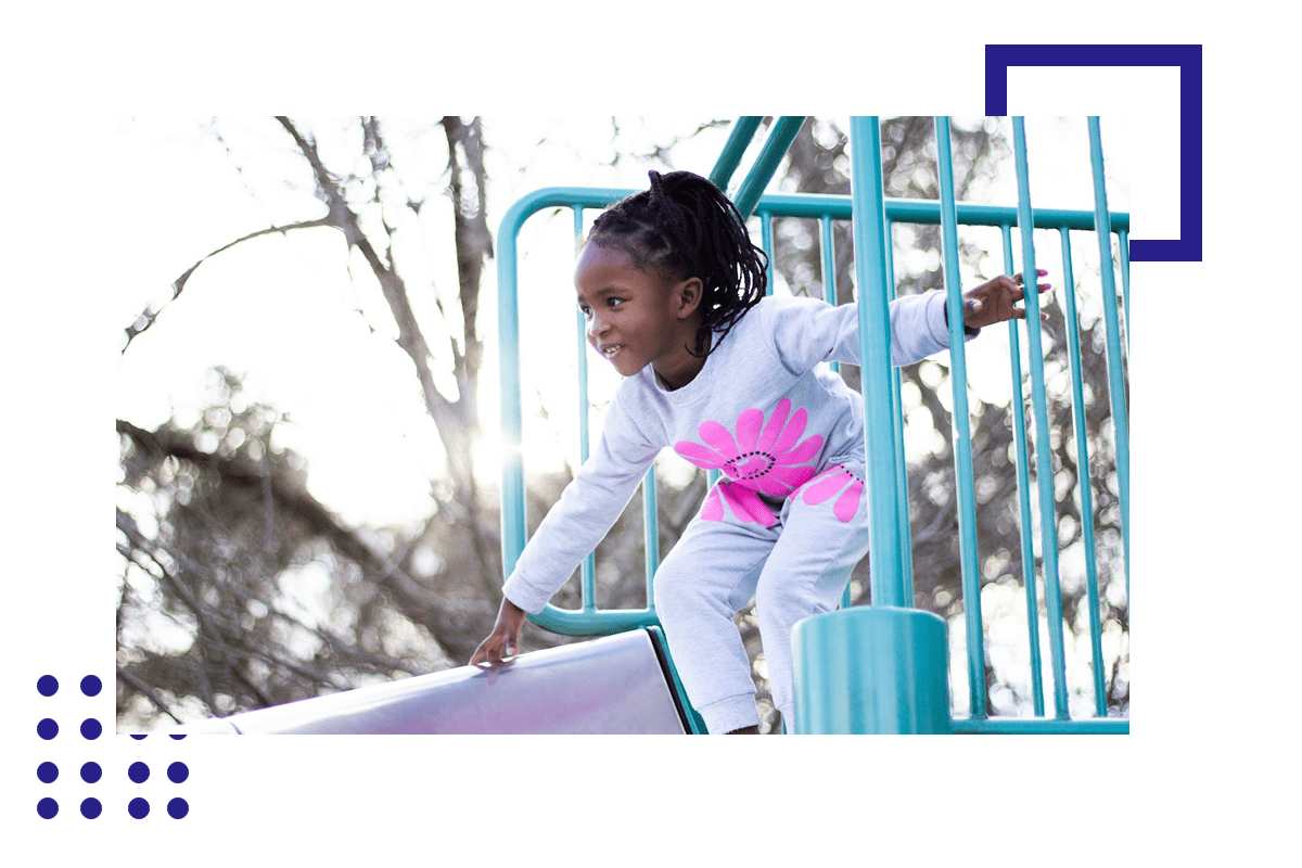 A young girl is playing on the slide.