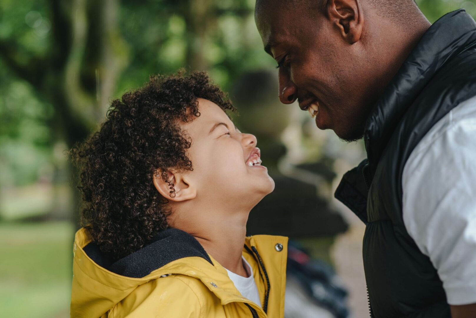 A man and child smiling at each other.